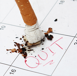 Cigarette butt on top of a calendar with the date circled and a written message saying 
